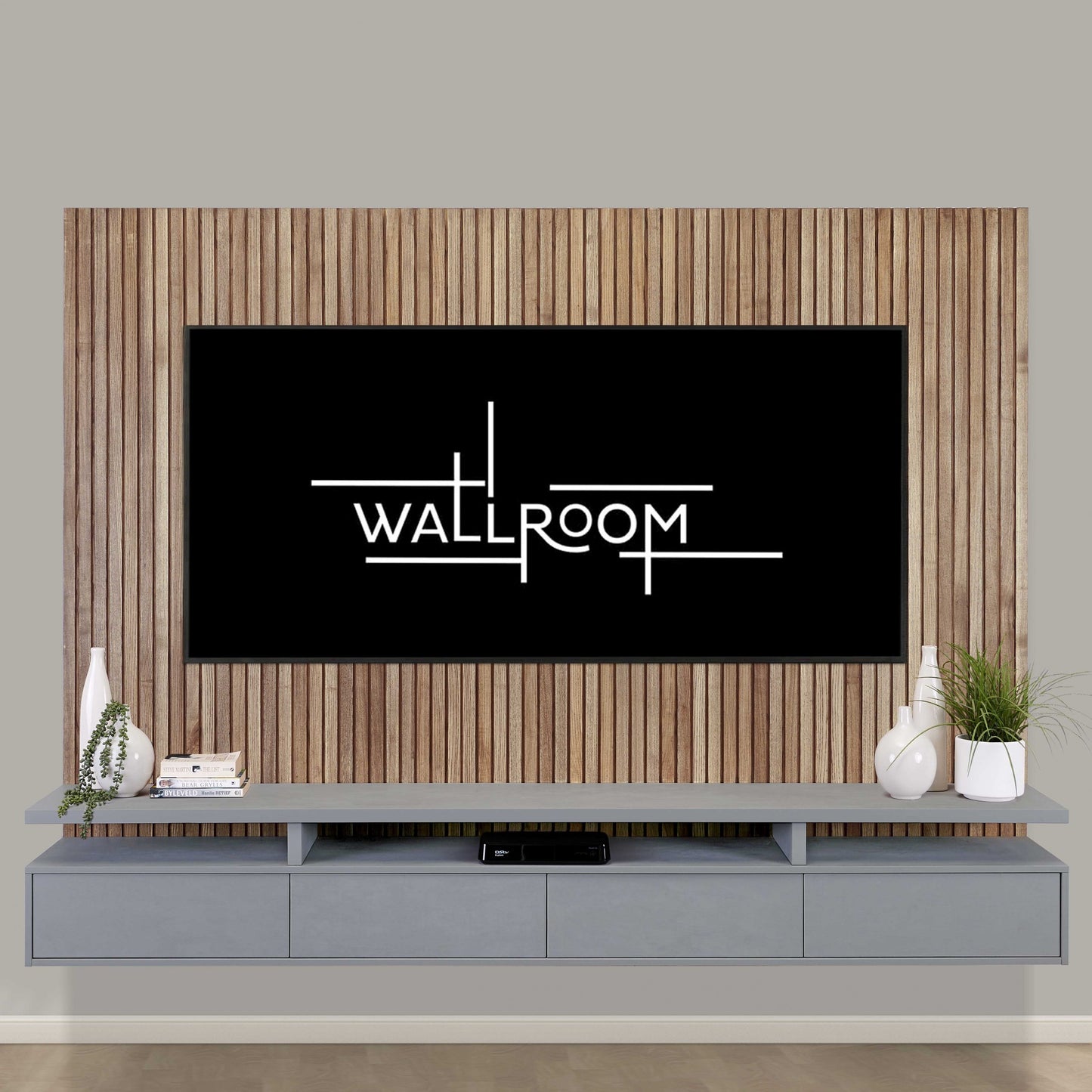 A modern living room featuring large flat-screen tv mounted on a minimalist gray floating tv stand, and includes a floating tv shelf, flanked by decorative plants.