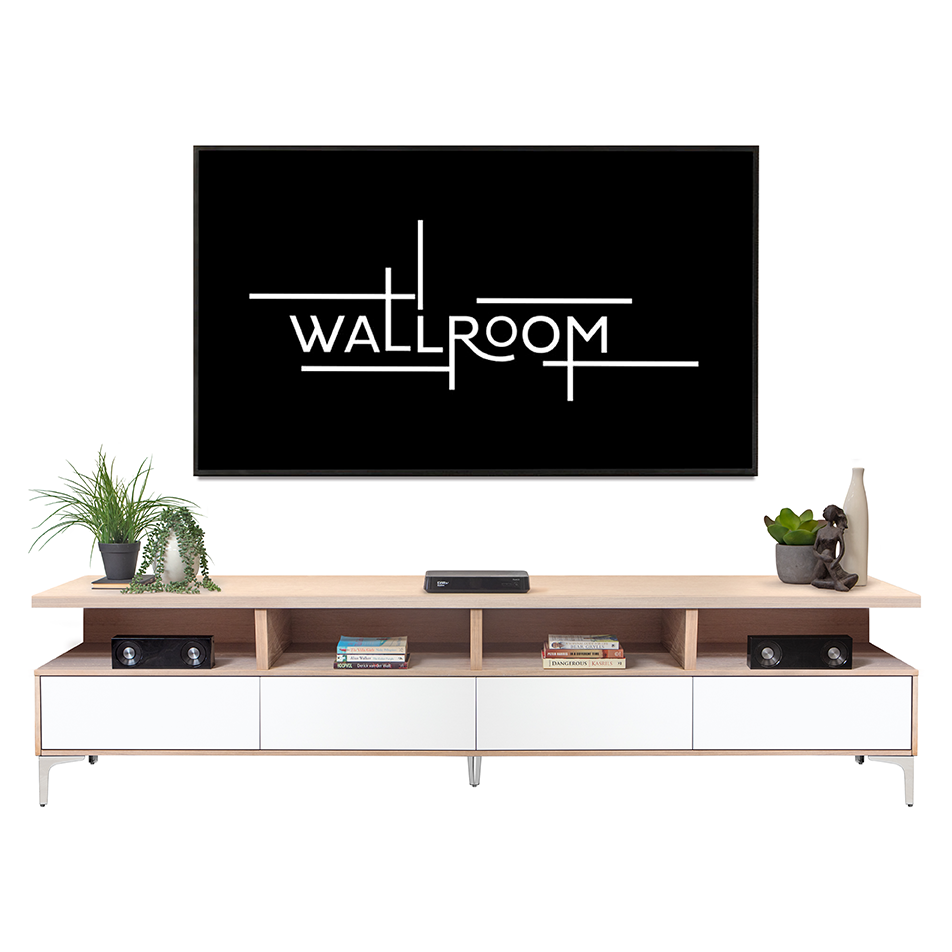 A sleek, modern living room setup featuring a mounted flat-screen tv on a simple, elegant white tv stand with decor accessories including a plant, books, and a sculpt