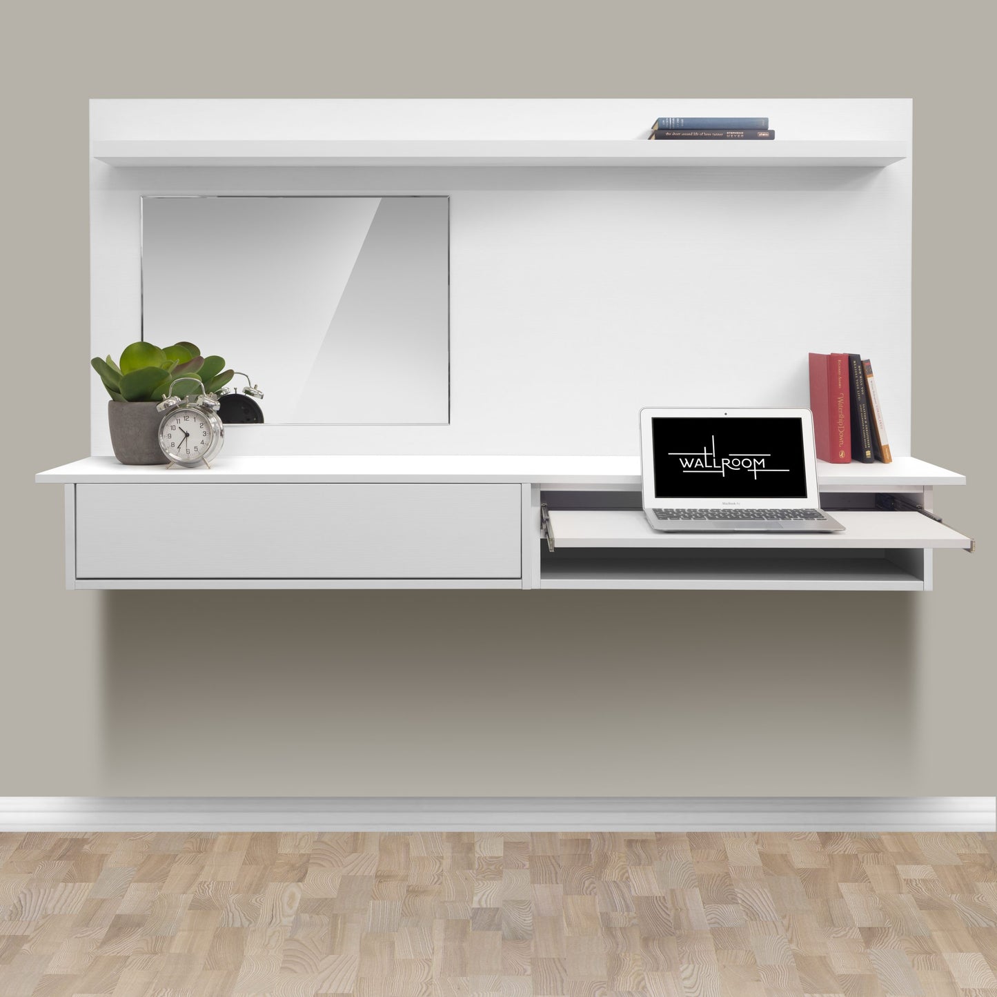 A modern minimalist floating dressing table setup featuring a laptop, with a decorative potted plant, clock, books, and a mirror above it, all arranged on a sleek white shelf against a light grey wall