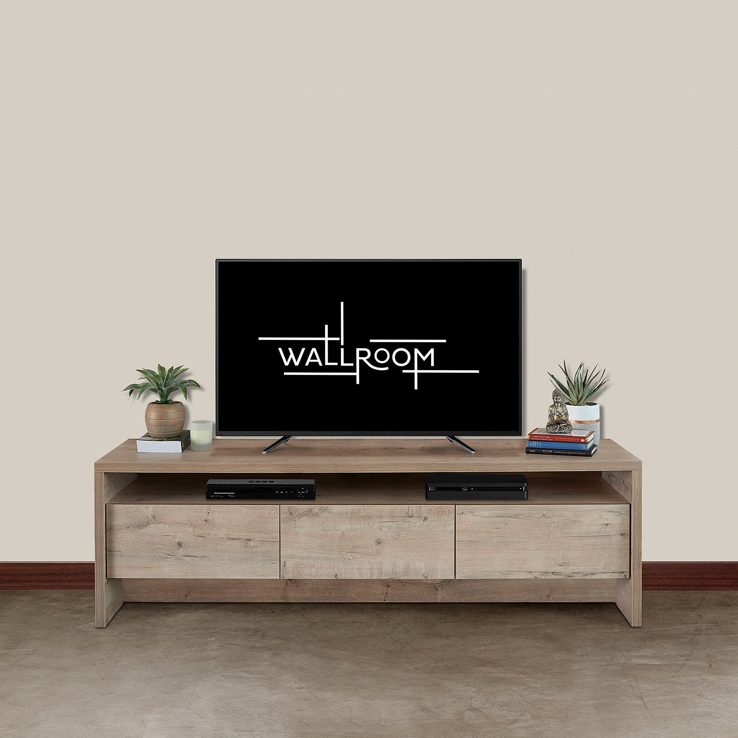 A minimalist living room with a flat-screen tv on a wooden media unit, flanked by two small potted plants and accompanied by a soundbar and a few decorative items.