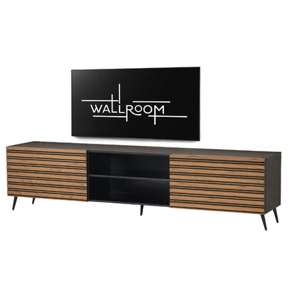 Modern entertainment center with a minimalist design, featuring a flat-screen tv mounted above a long, two-toned media console with slatted wood doors and a central black compartment.