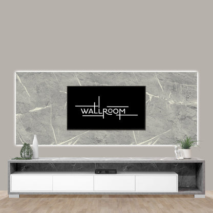 A sleek, modern living room featuring a flat-screen plasma tv mounted on a textured grey marble wall panel, with a low-profile white entertainment unit beneath and minimalistic decor on a clean, neutral backdrop.