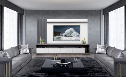 A modern living room with symmetrical design featuring two gray sofas, a large ocean artwork above a sleek media console with TV table and backboard, and a central glass-top table on a dark rug.