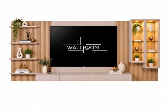 A modern wall-mounted media console and shelving unit in light wood and beige tones, centered around a large black TV screen displaying the WALLROOM logo. Decorative plants, vases, books, and illuminated display shelves are arranged on both sides against a clean white background.